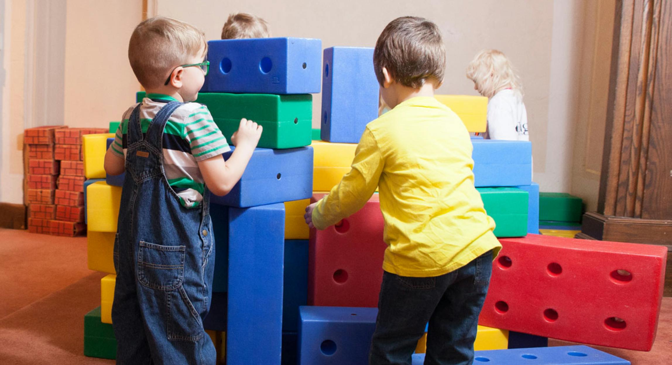 Children playing with large colorful building blocks