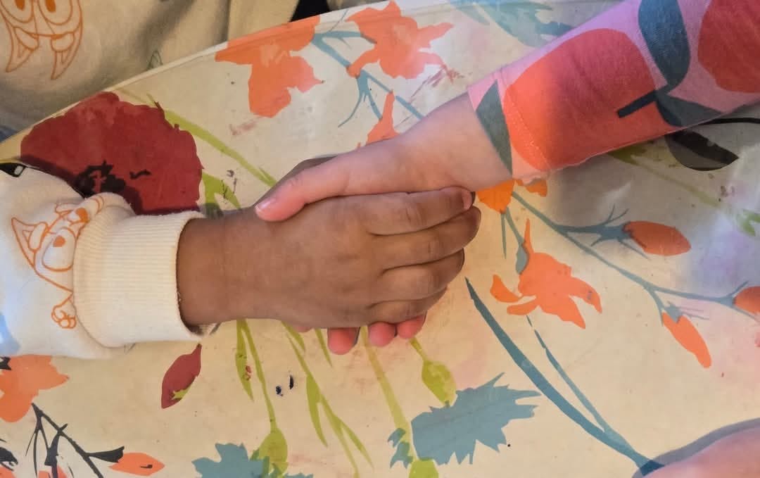 Two children holding hands