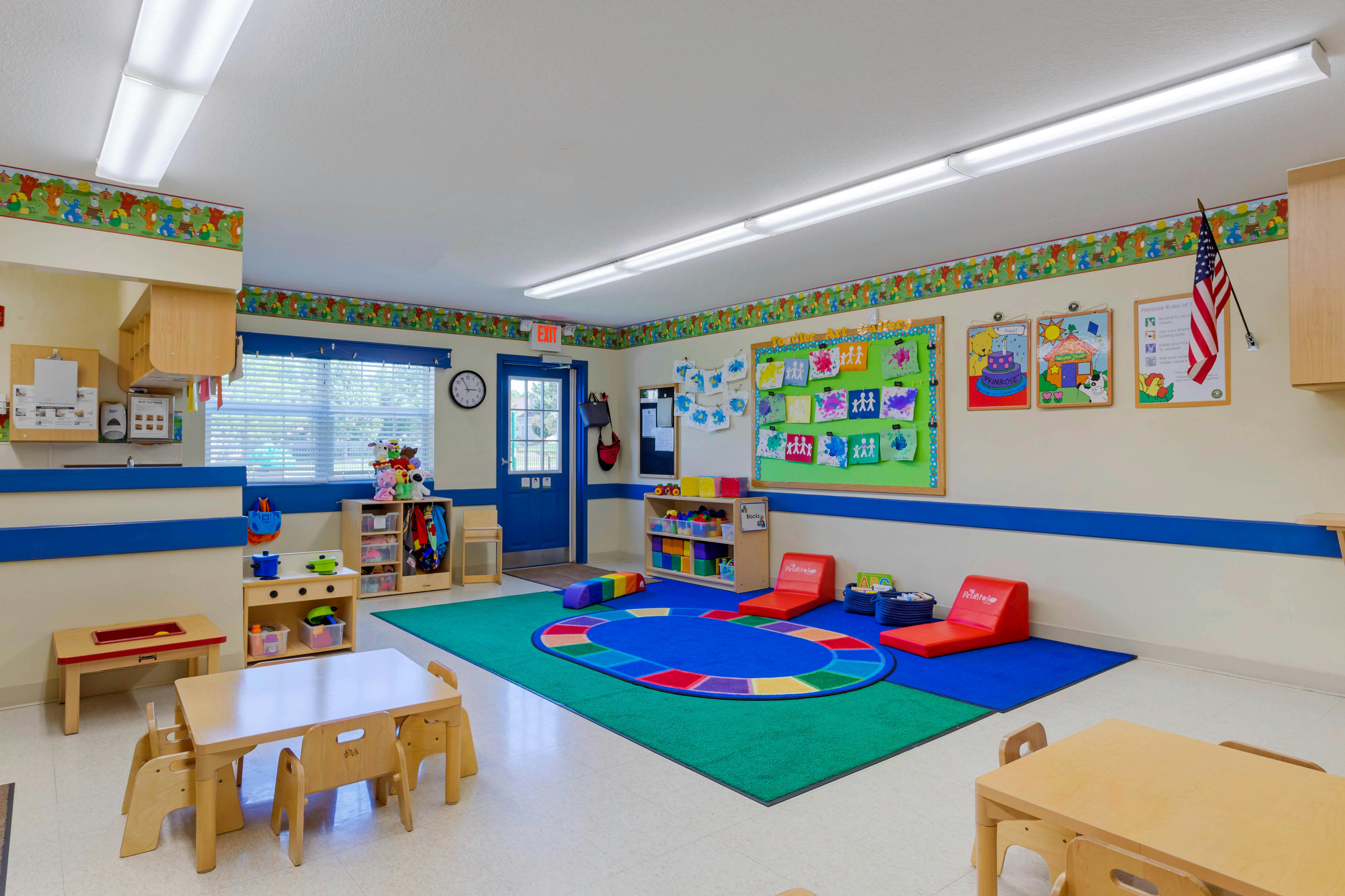 Colorful classroom with child-sized furniture and artwork on the walls