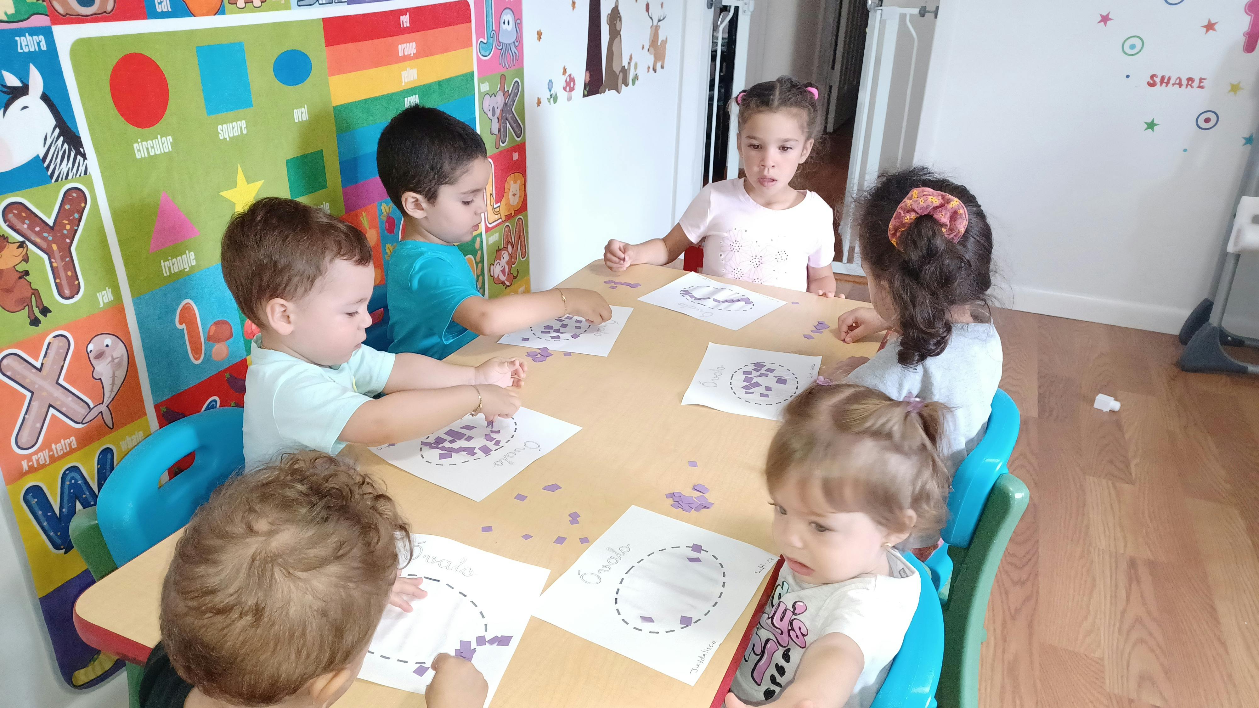 Children sitting at a table doing an activity