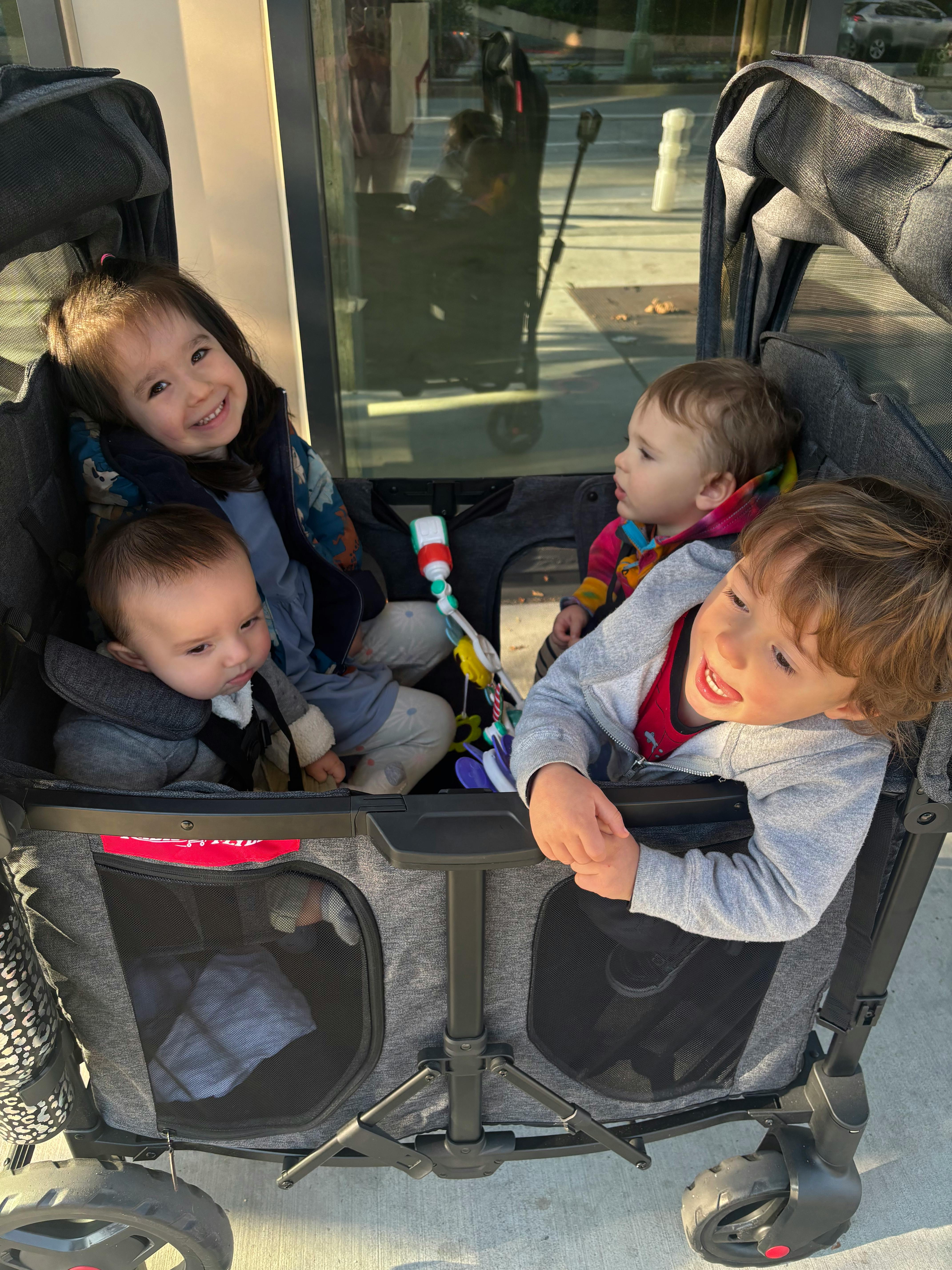 Three children in a stroller