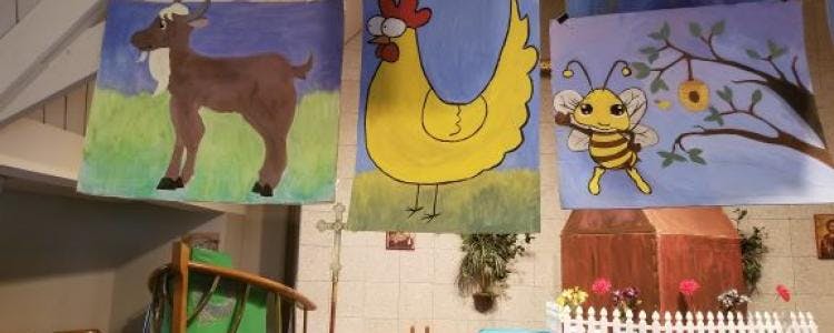 Three banners with cartoon drawings of a goat, a chicken, and a bee