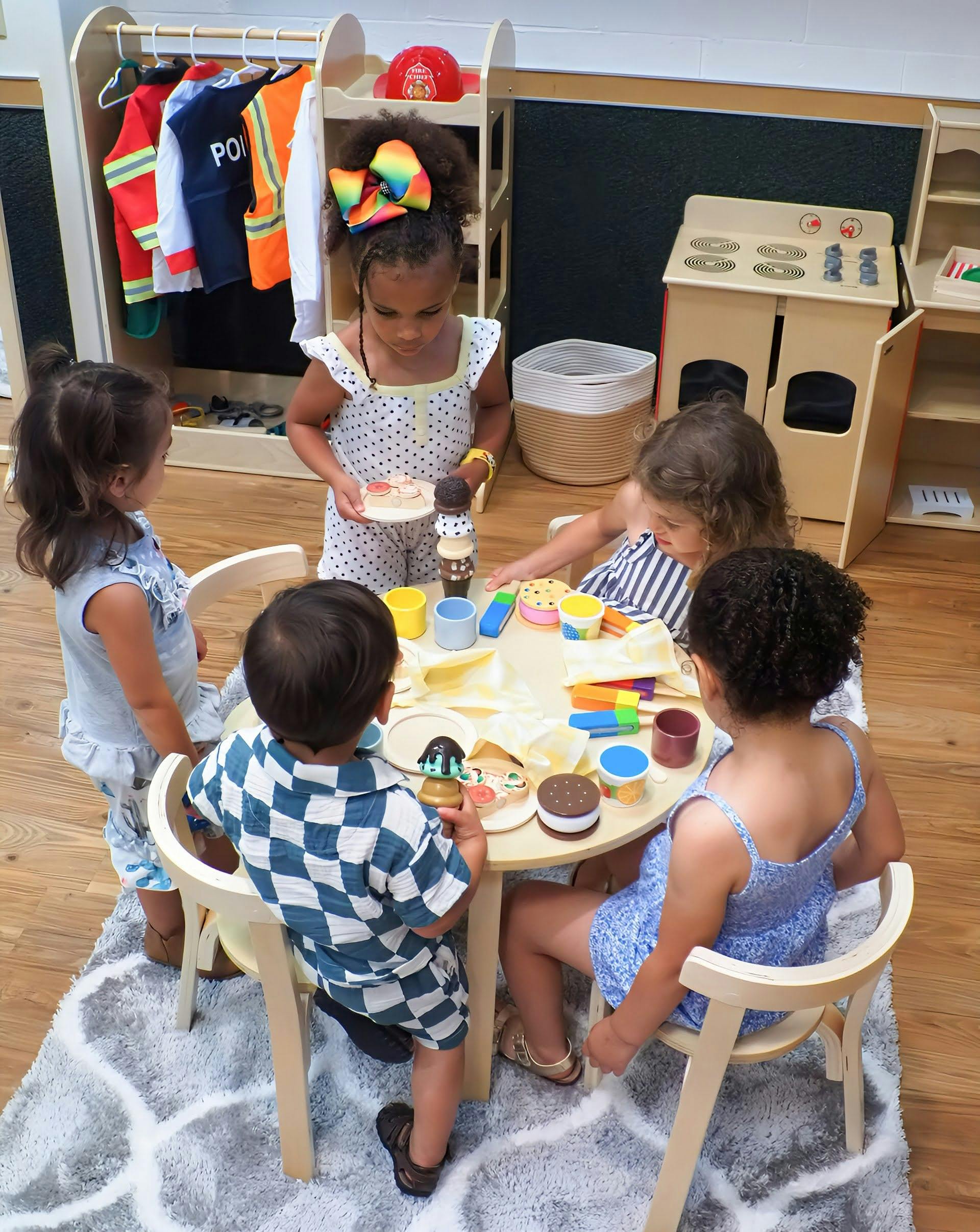 Children playing with toy food at a small table