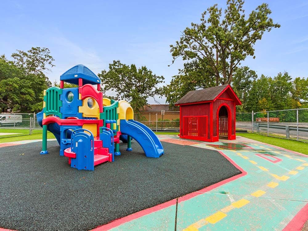 Colorful playground with slides and a small red playhouse