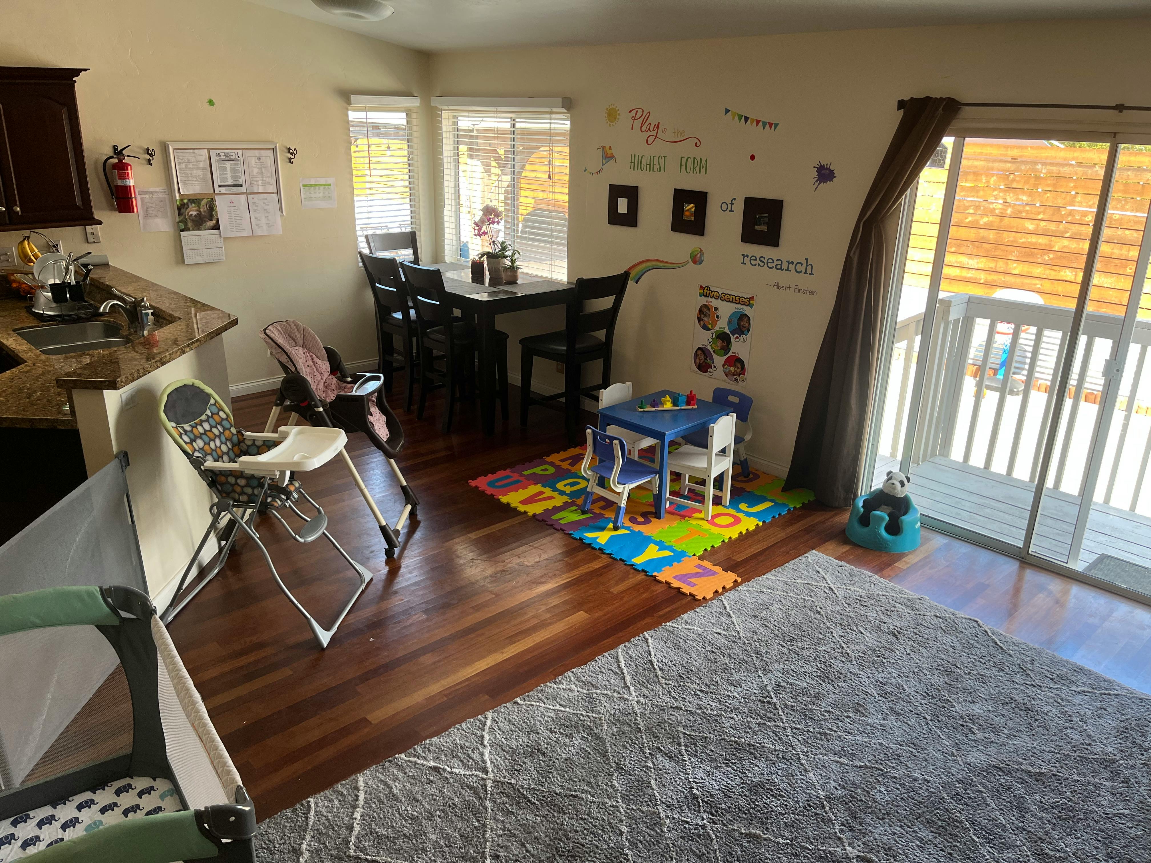 Kitchen and dining area with child's play table and high chair