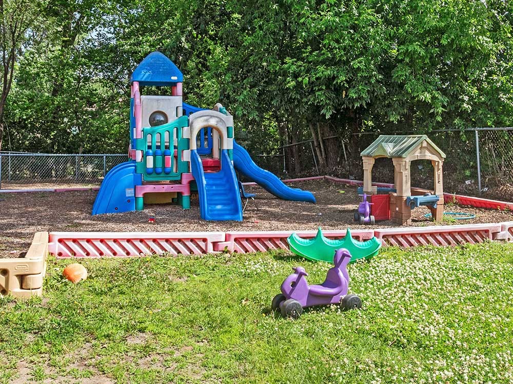 Colorful playground structure with slides and a small playhouse