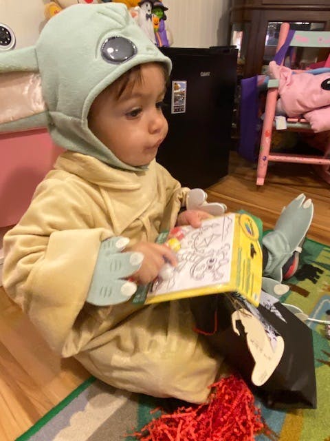 Child in costume playing with a toy