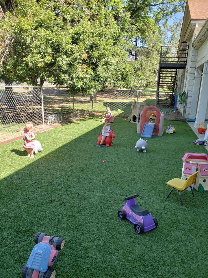 Children playing with toys on artificial grass