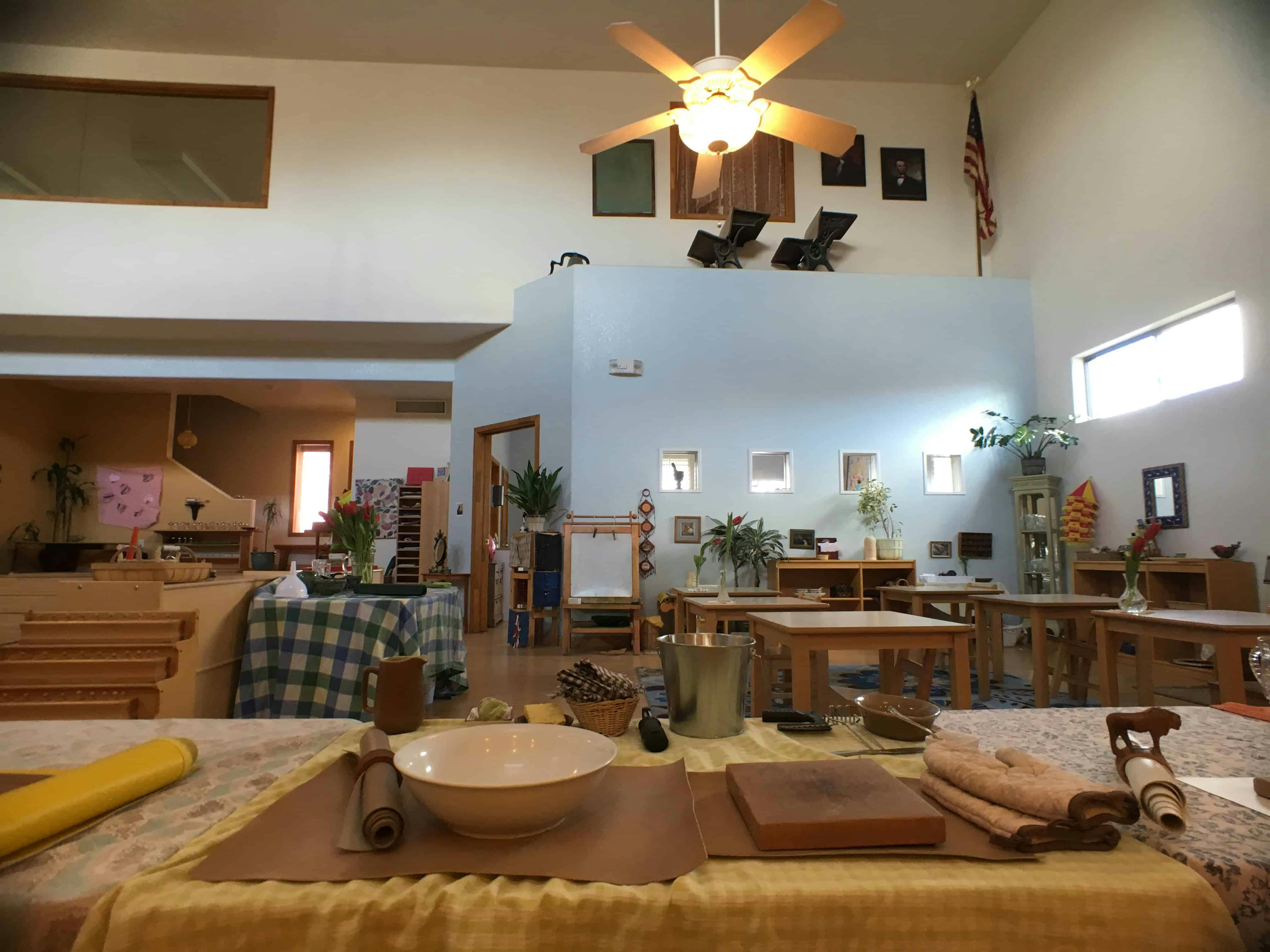 Classroom with tables, chairs, and a ceiling fan