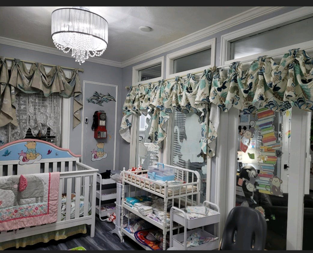 Nursery room with a white crib and changing table