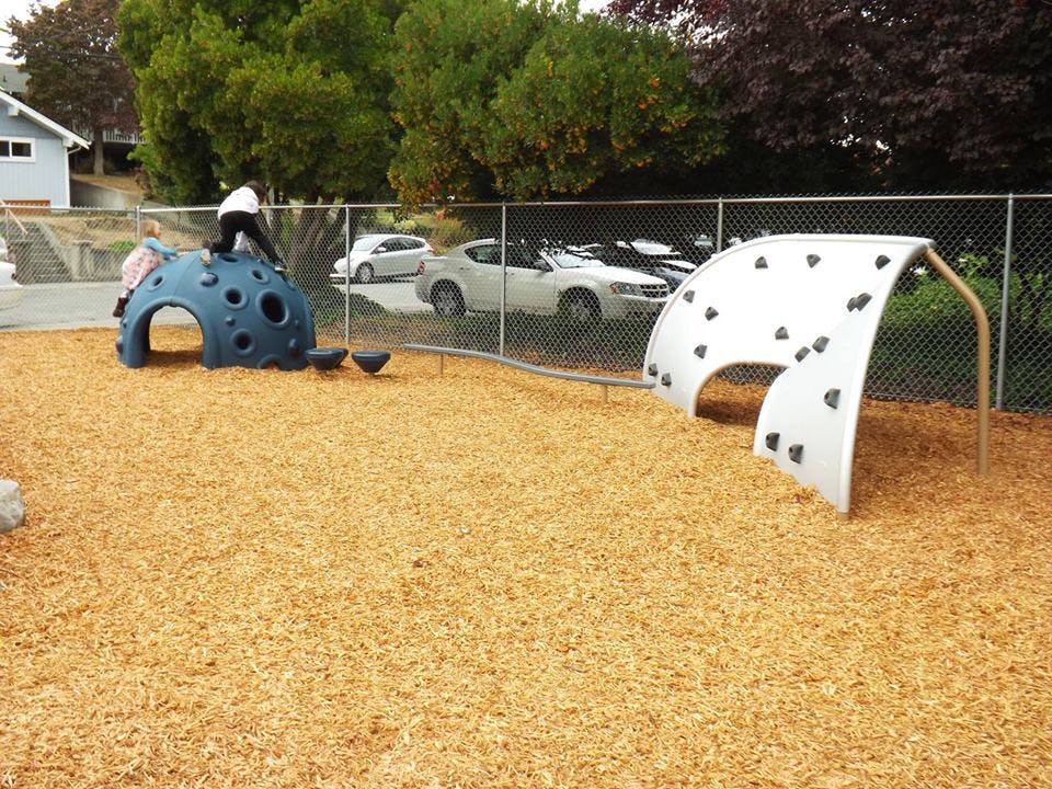 Person climbing on a blue dome in a playground
