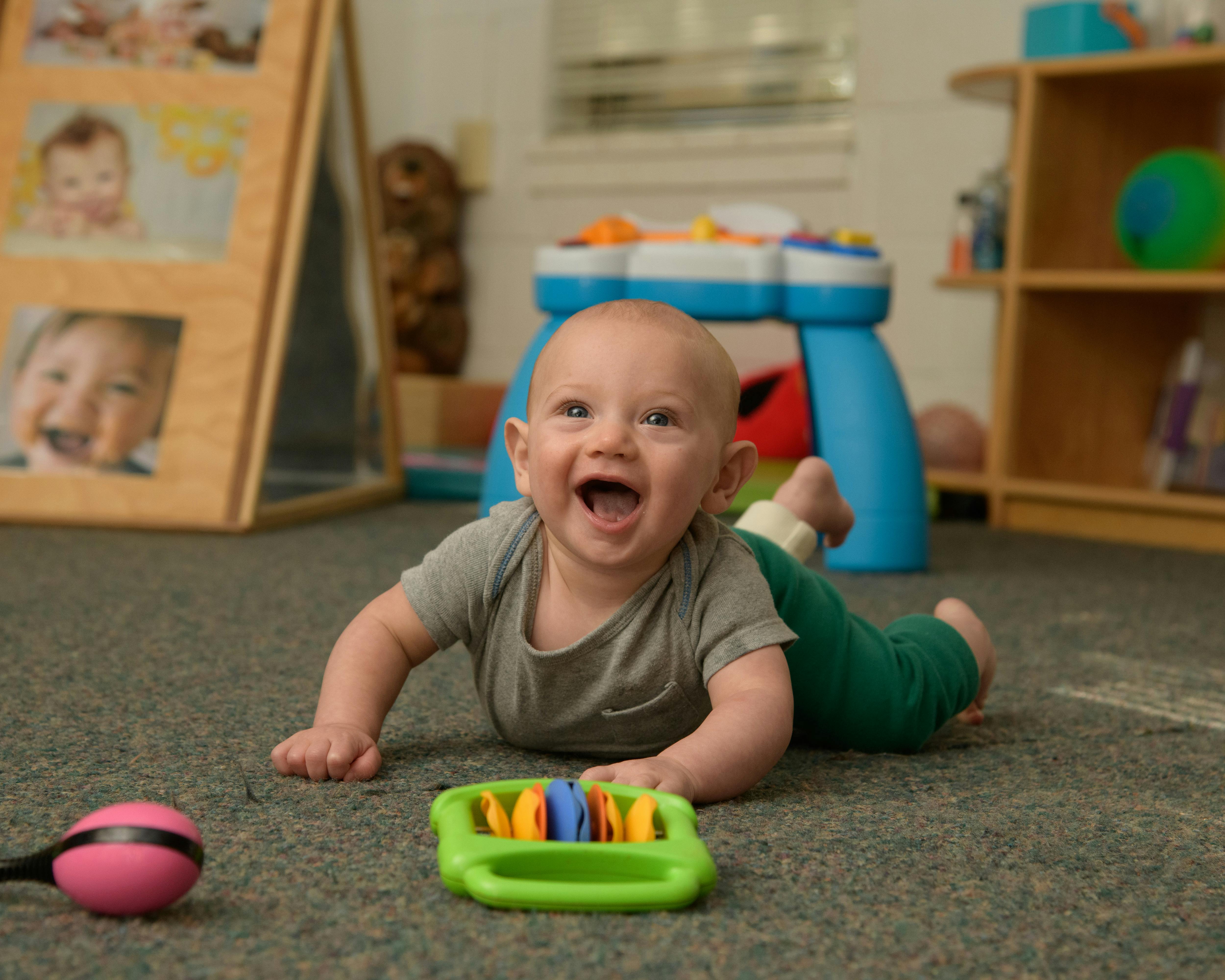 Baby crawling on floor with toy