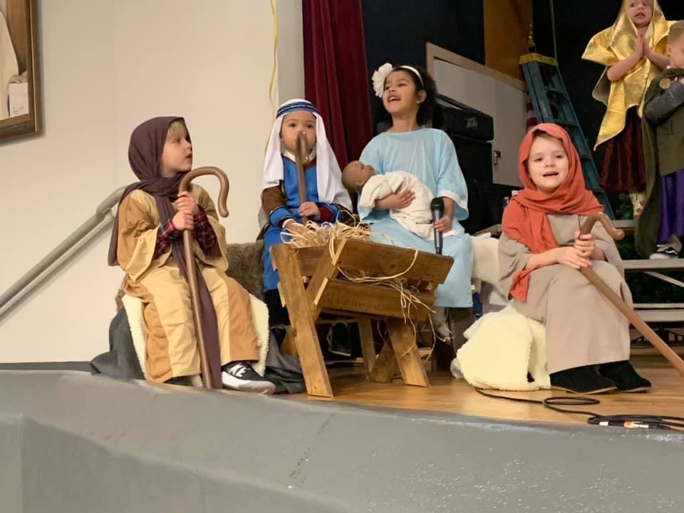 Children in costumes performing a play