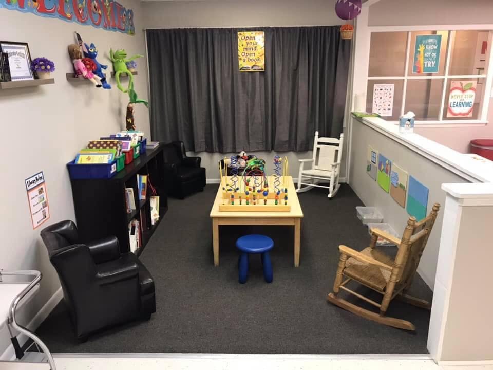 Children's play area with a table, chairs, and toys