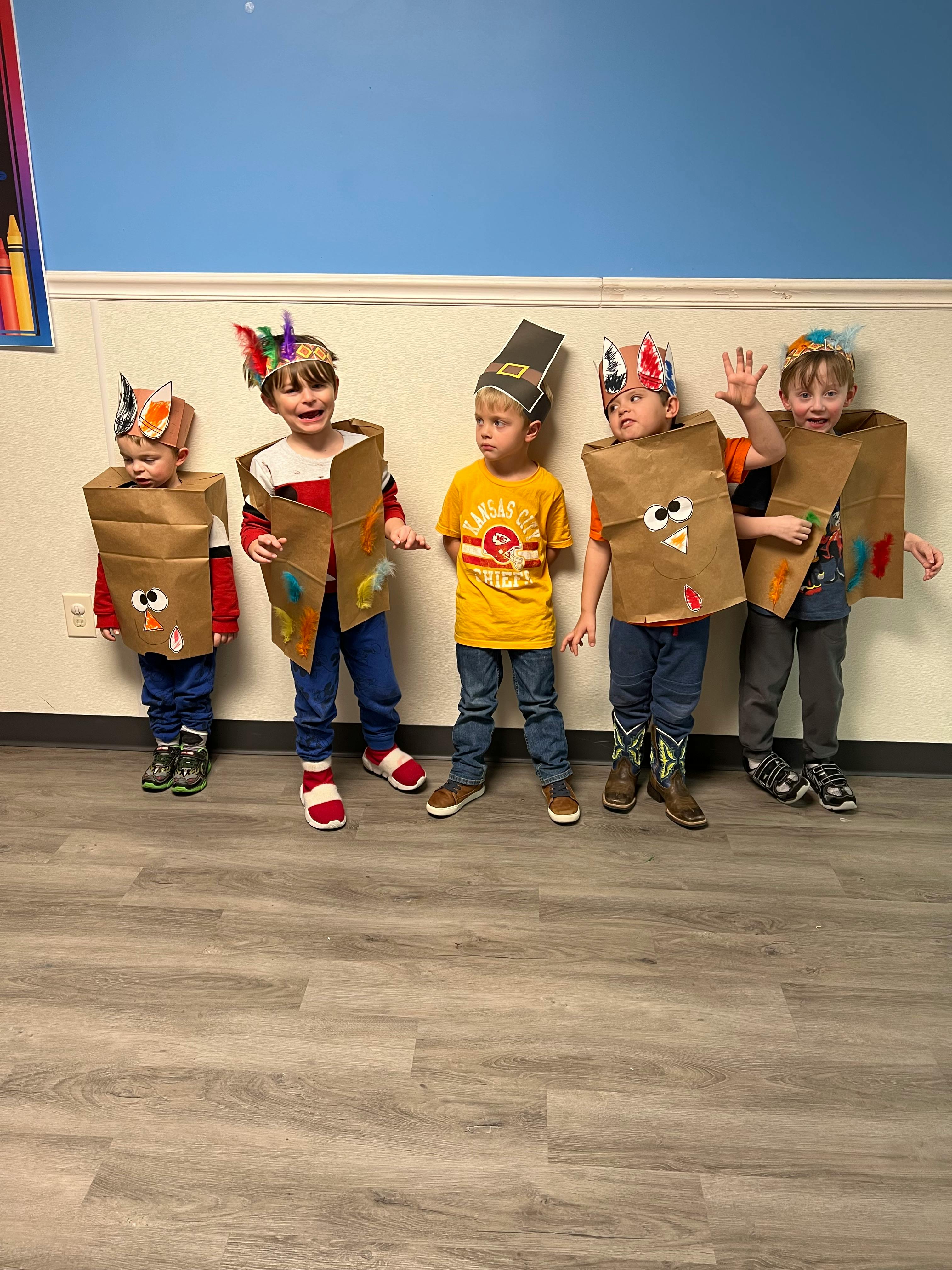 Five children in costumes made from paper bags