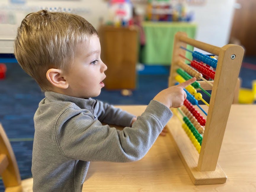 Child playing with an abacus