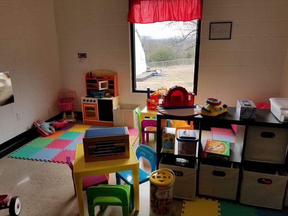 Playroom with colorful floor mats and various toys