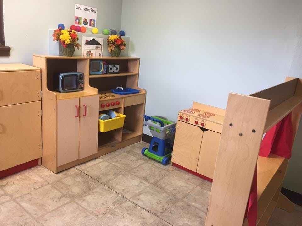 Children's play kitchen and furniture in a room