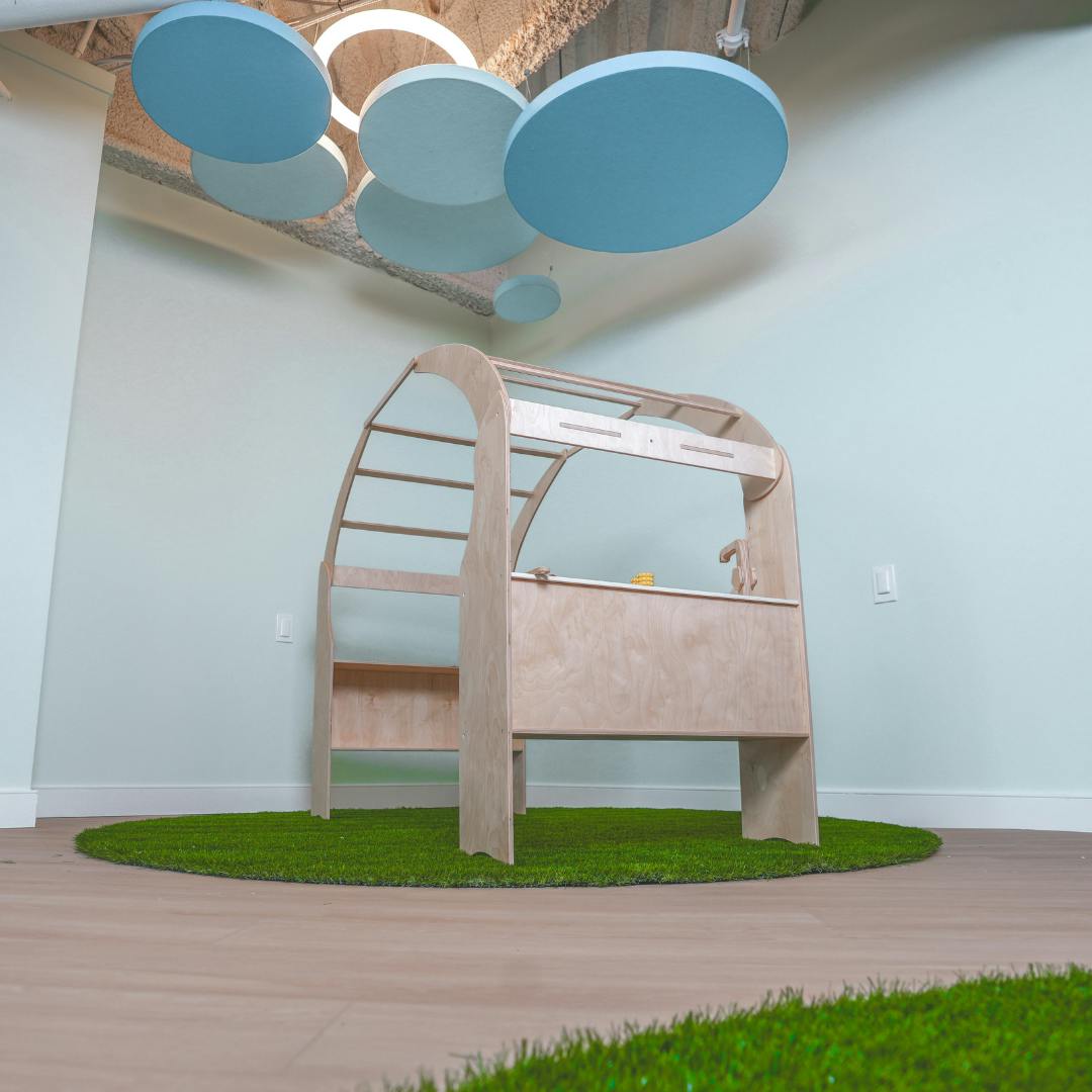 Wooden climbing structure on a circular green mat