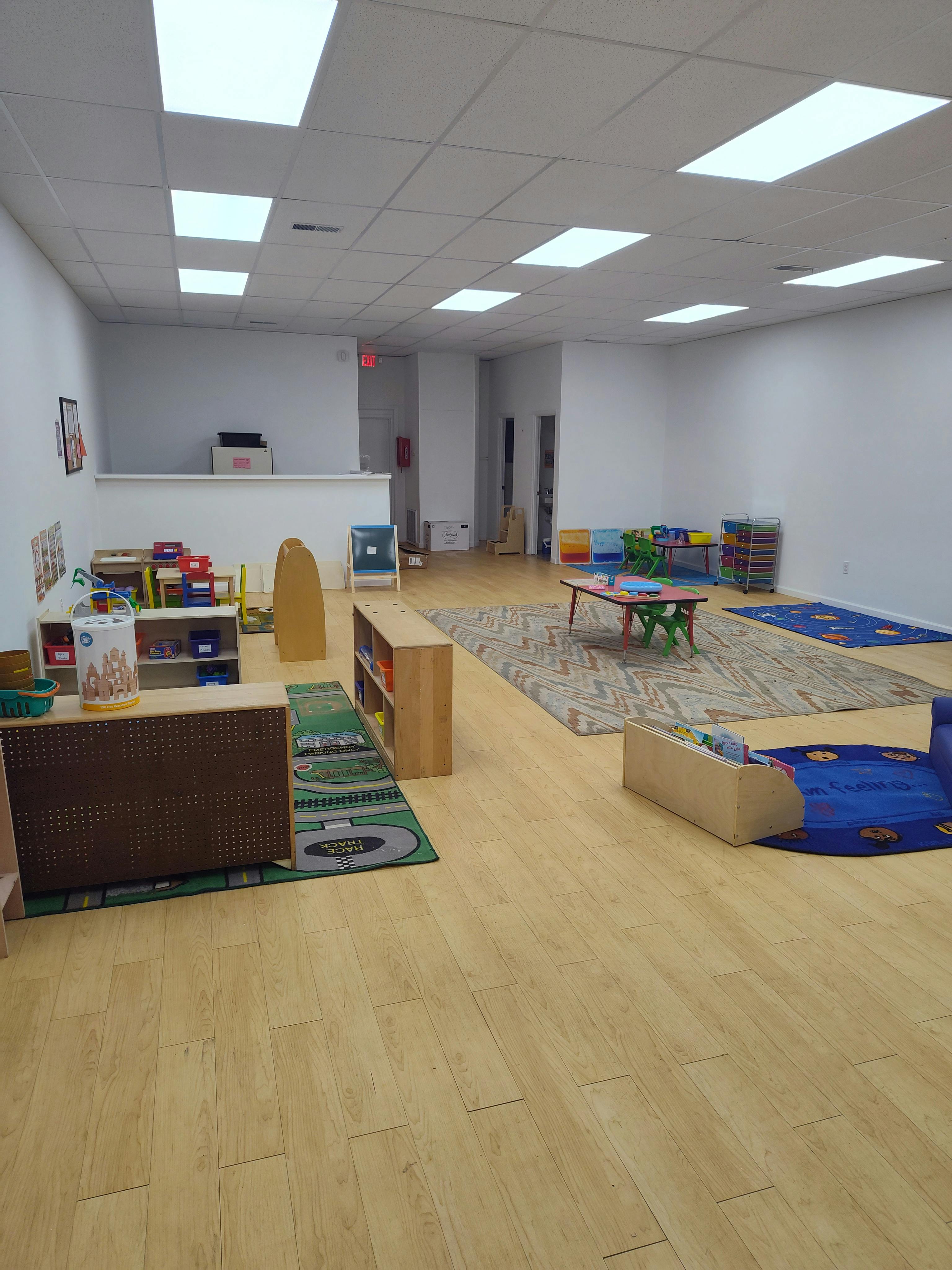 Empty classroom with play mats and small furniture