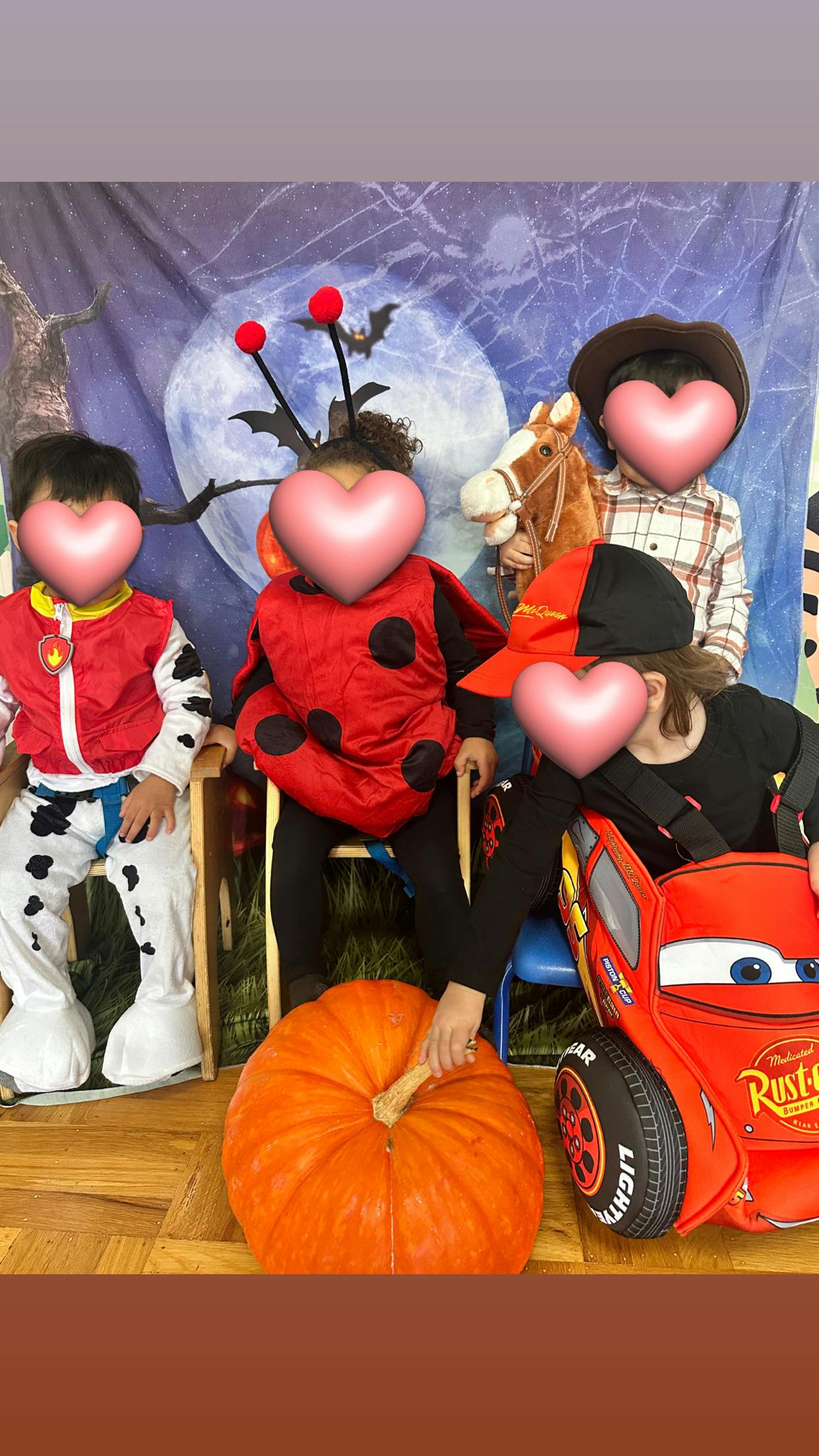 Children in costumes with a pumpkin