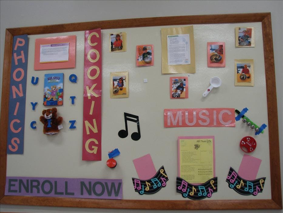 A classroom bulletin board with sections for phonics, cooking, and music