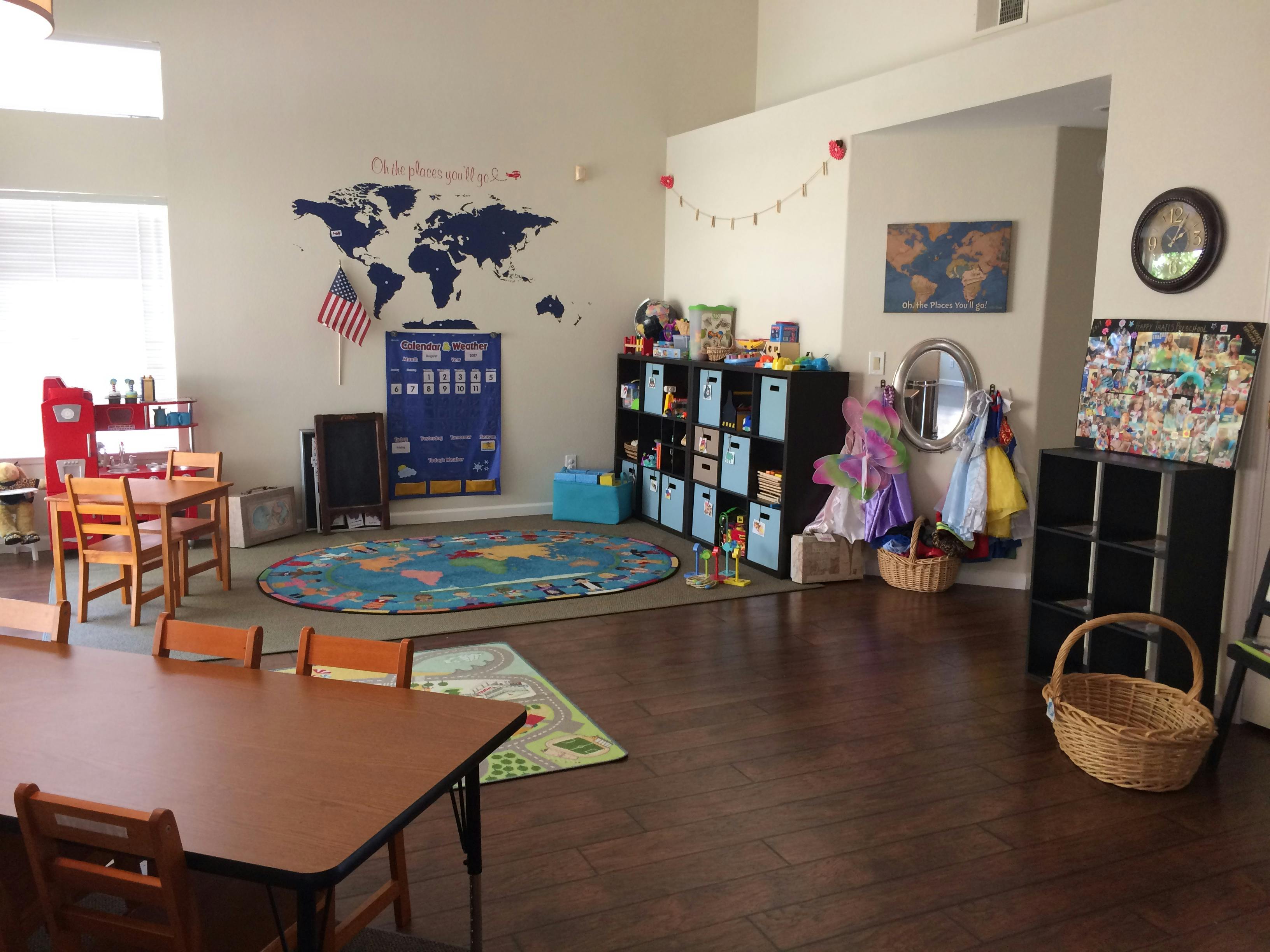 Classroom with a world map on the wall, tables, chairs, and storage shelves
