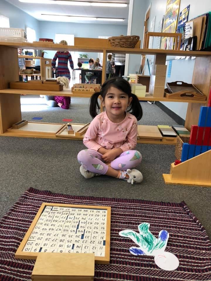 Child sitting on floor in a classroom