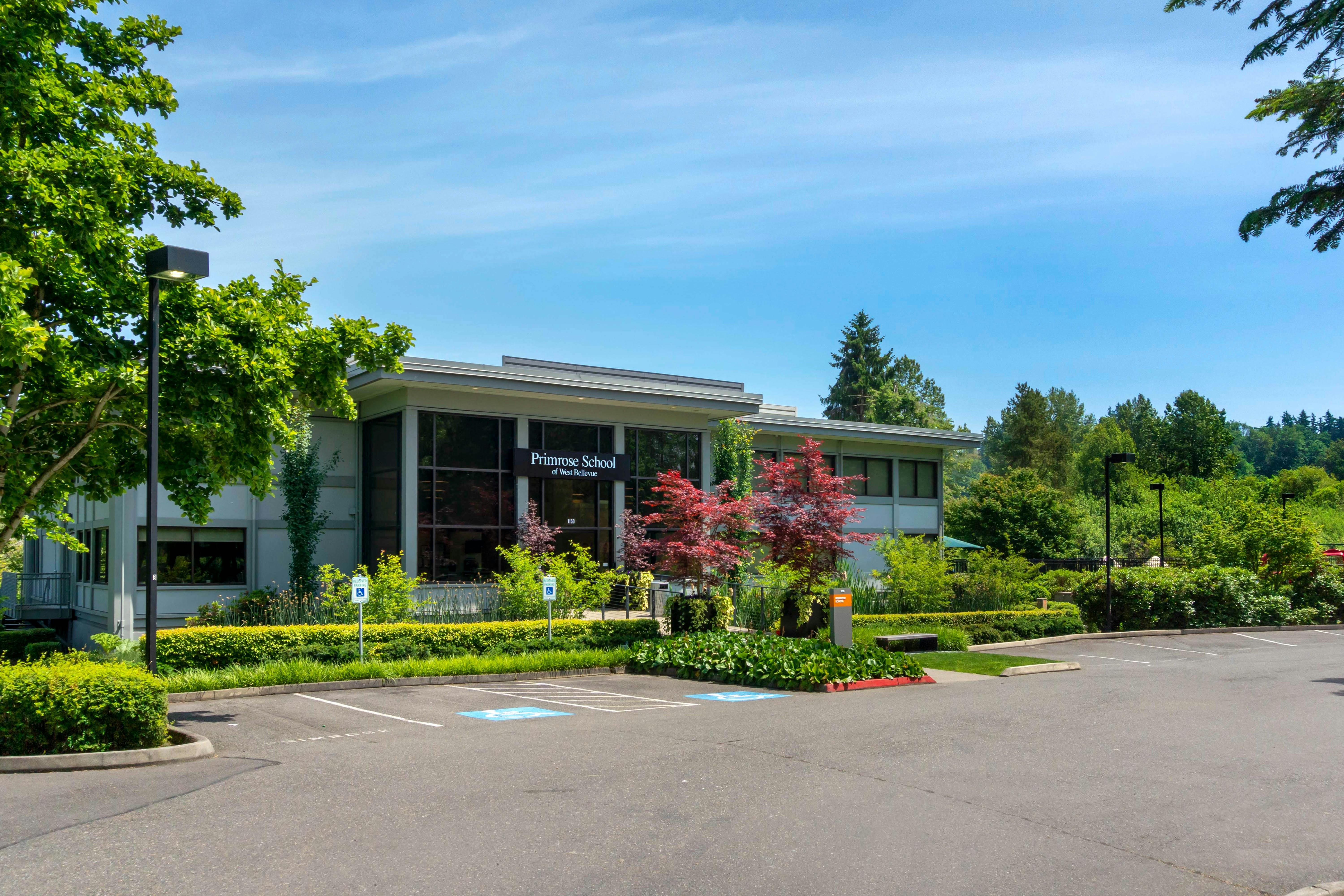 Primrose School of West Bellevue building facade with parking lot and landscaping