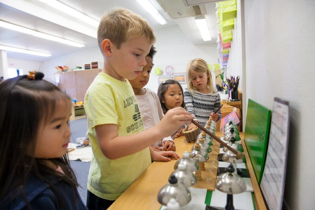 Children playing with handbells in a classroom