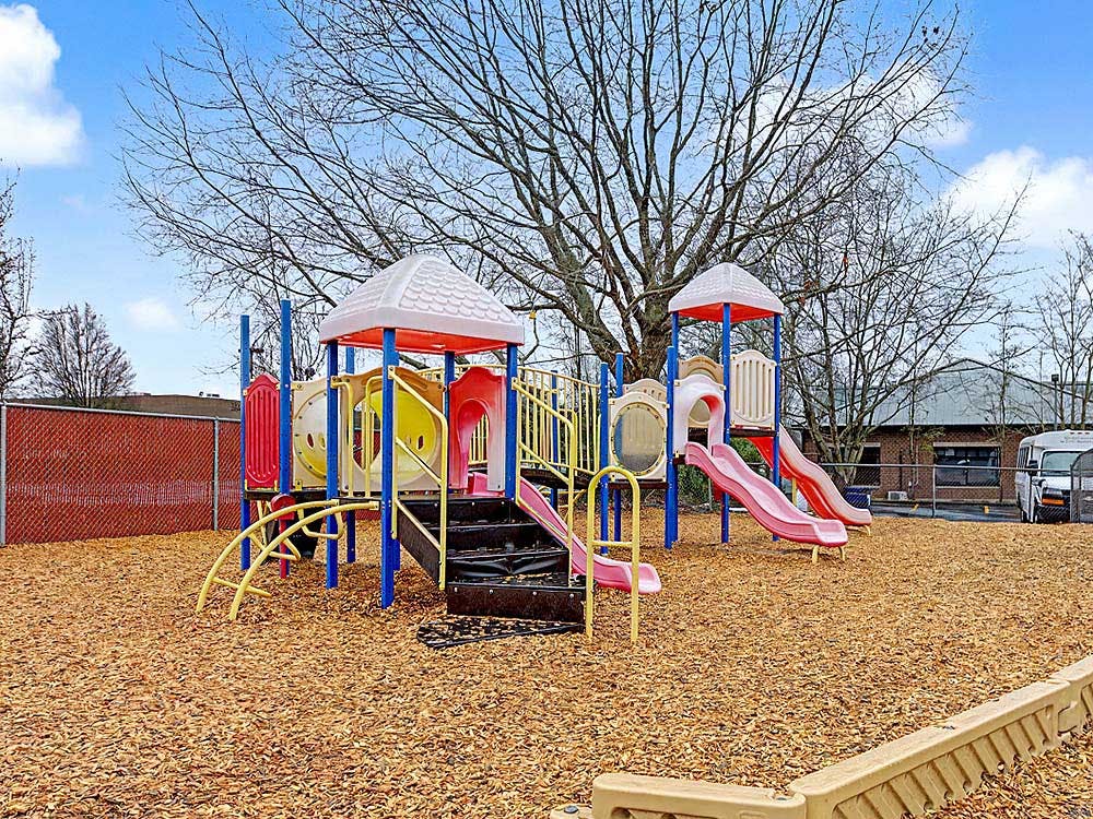 Colorful outdoor playground structure with slides and steps
