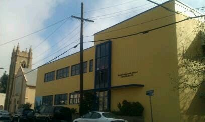 Yellow building with a tall church tower in the background