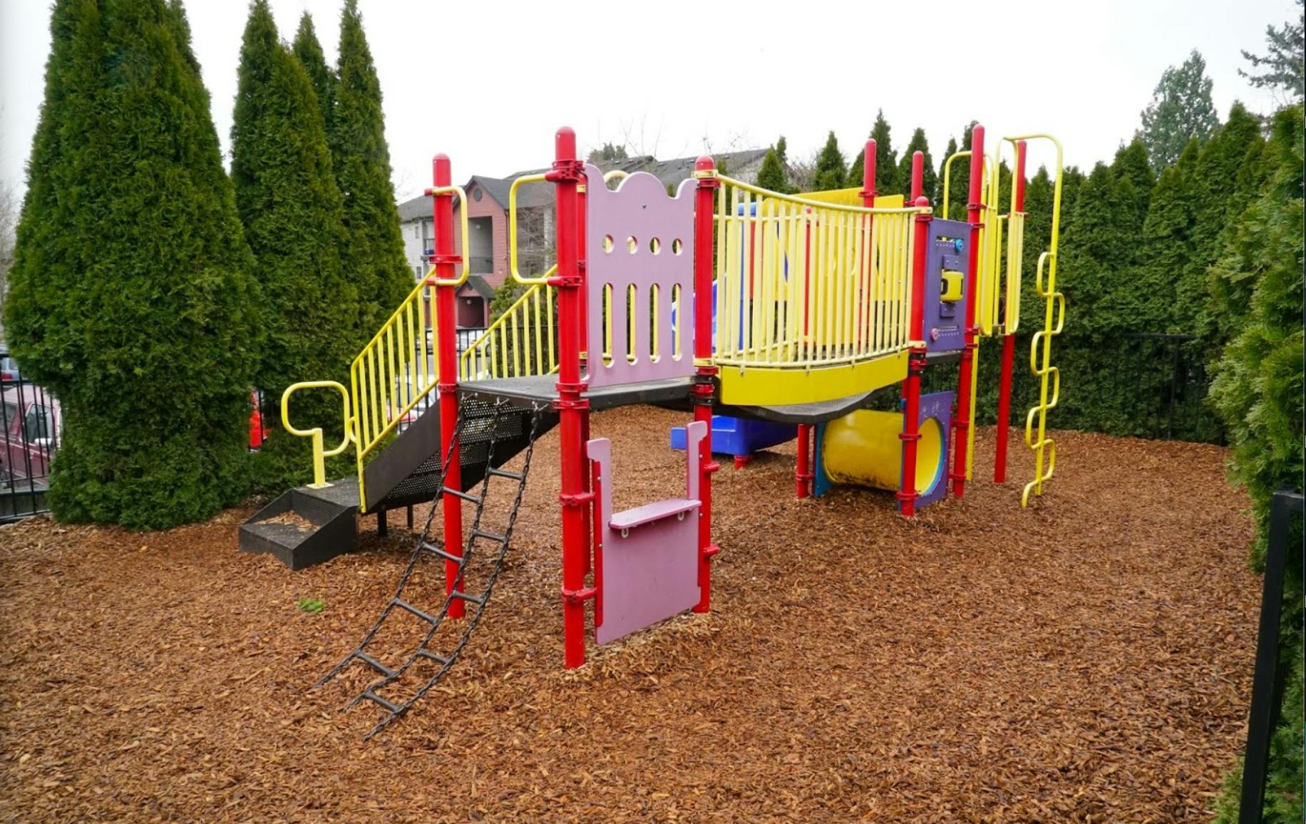 Playground structure with slides and climbing elements
