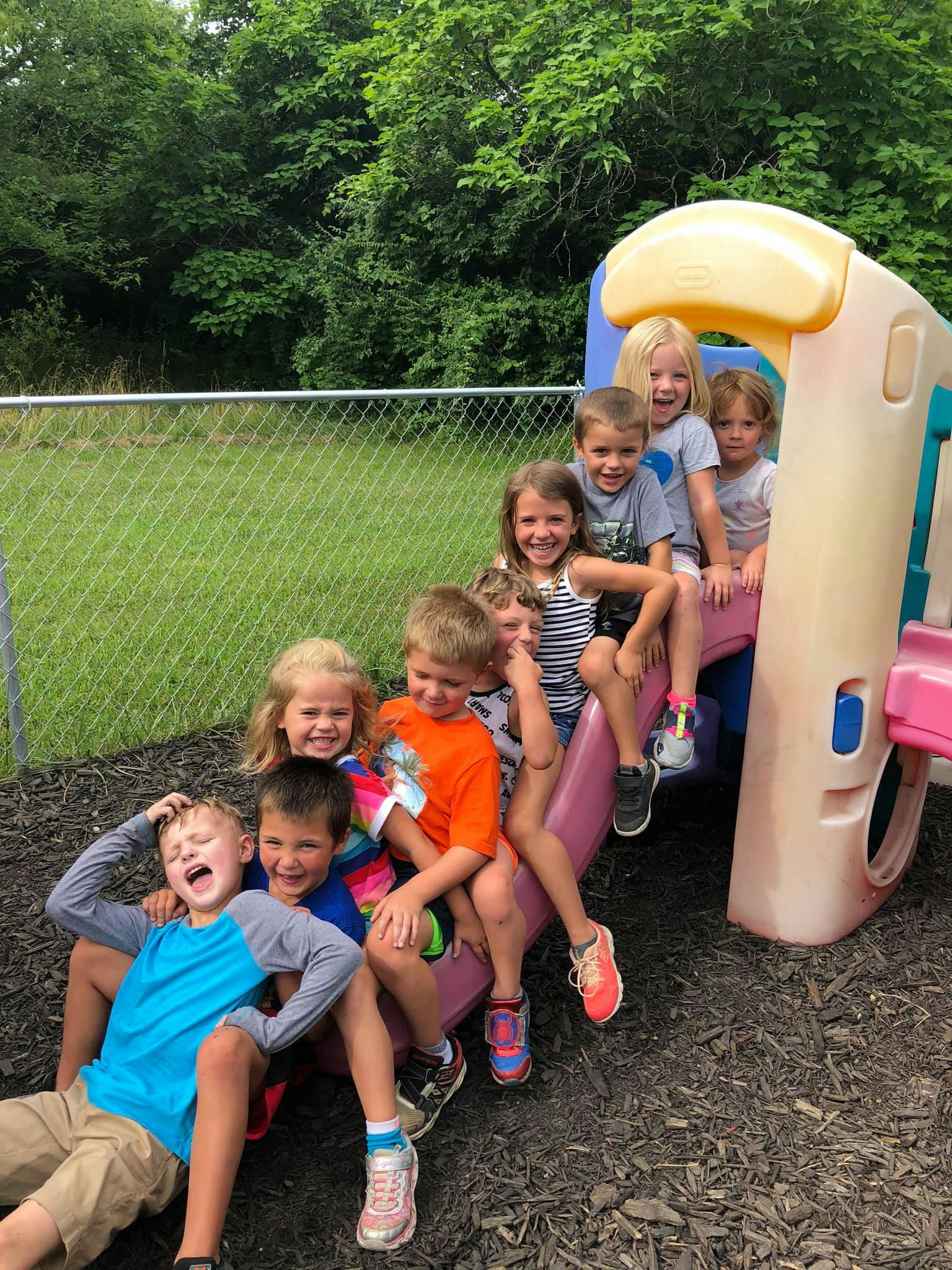Group of children on and around a playground slide
