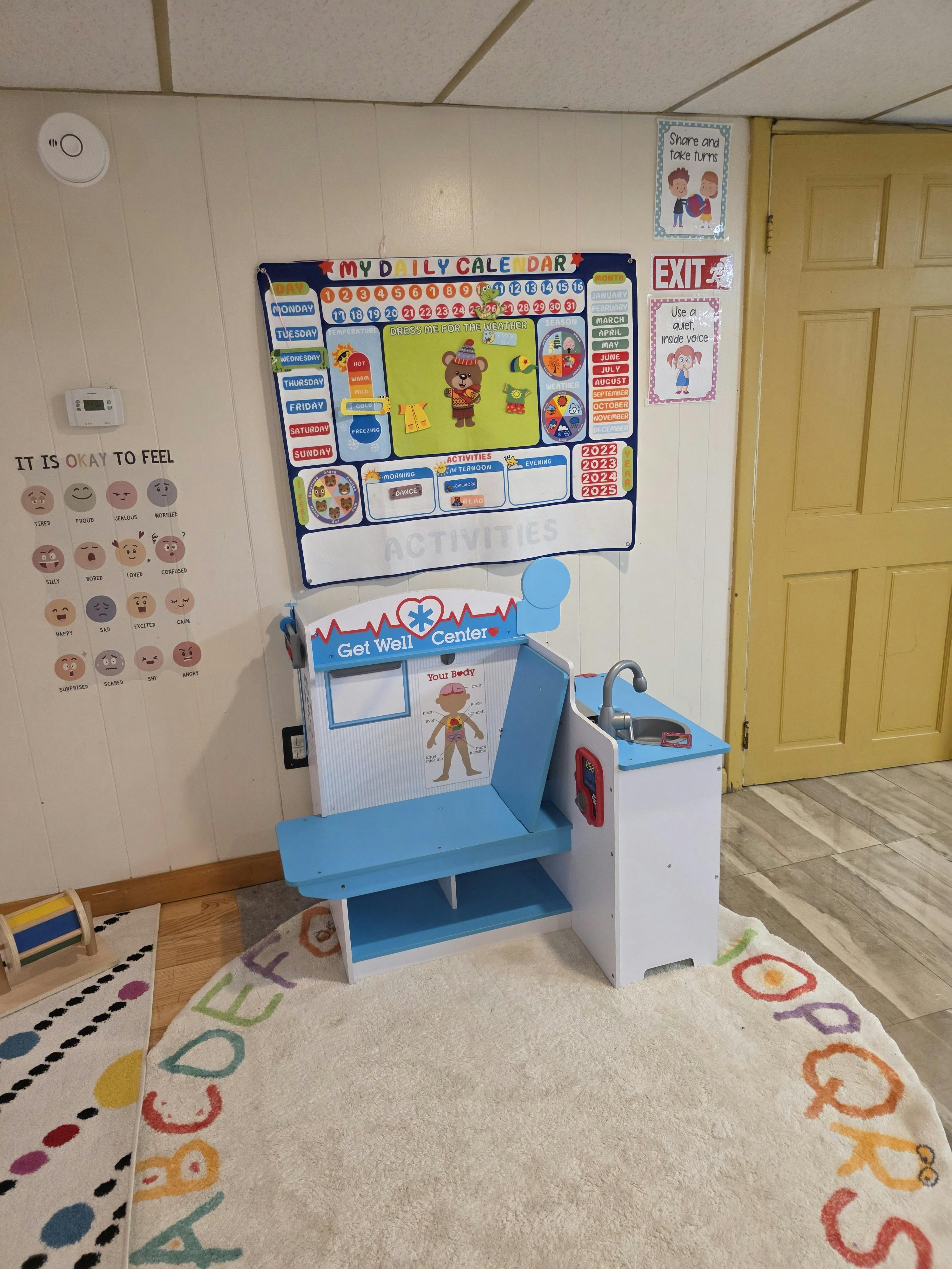 A toy medical center and a wall calendar in a classroom