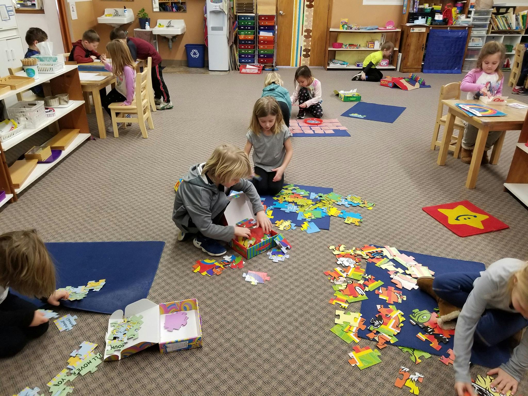 Children playing with puzzles and toys in a classroom