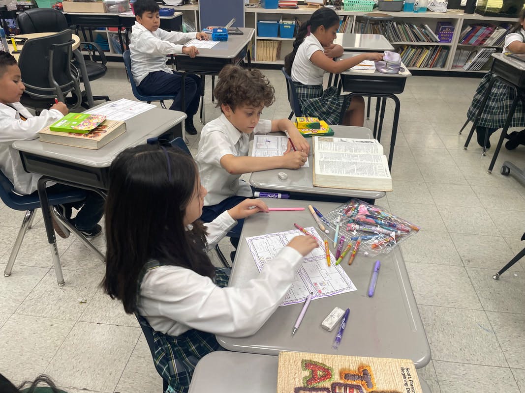 Children sitting at desks in a classroom