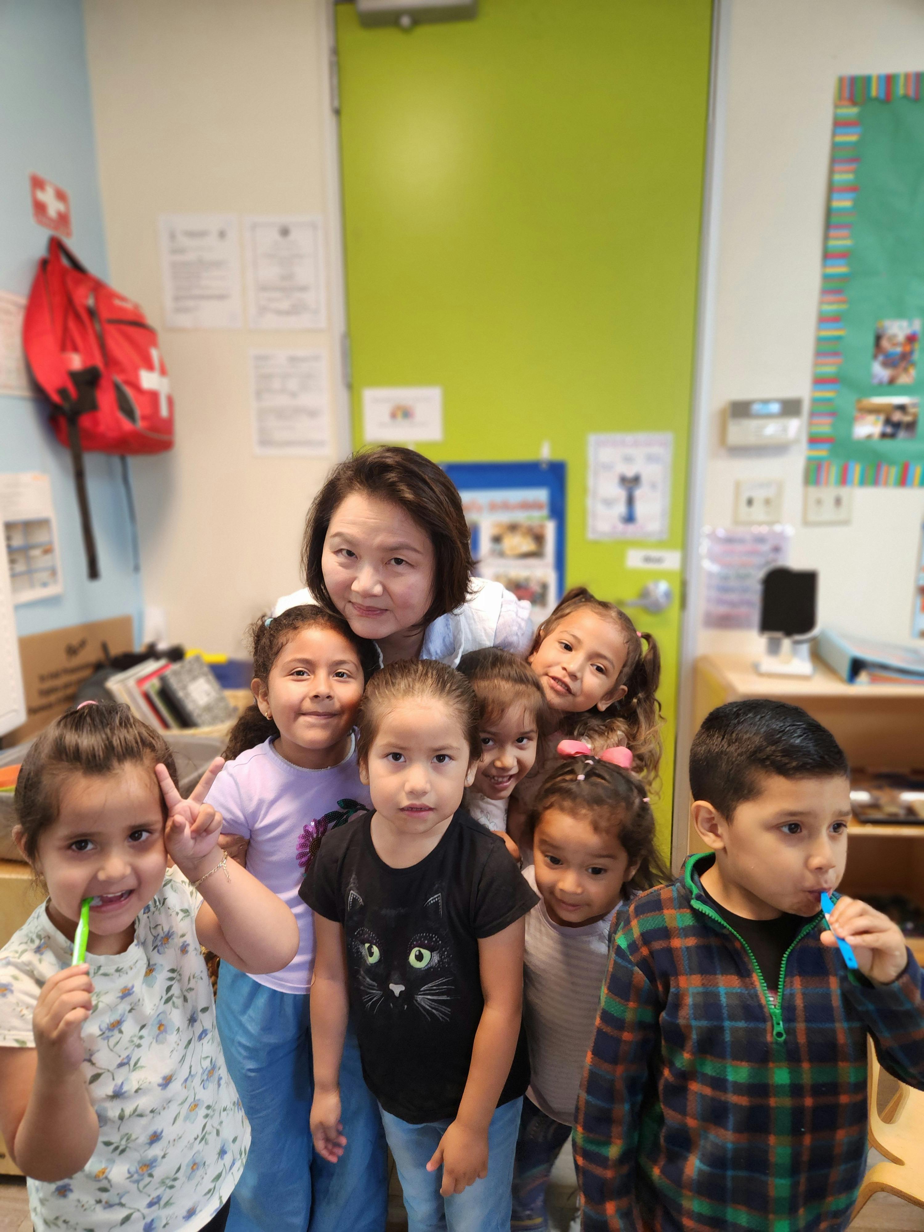 Adult and multiple children in a classroom