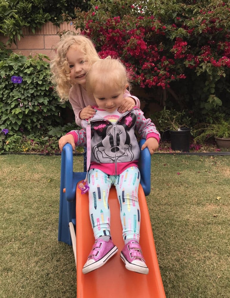 Two children on a small slide