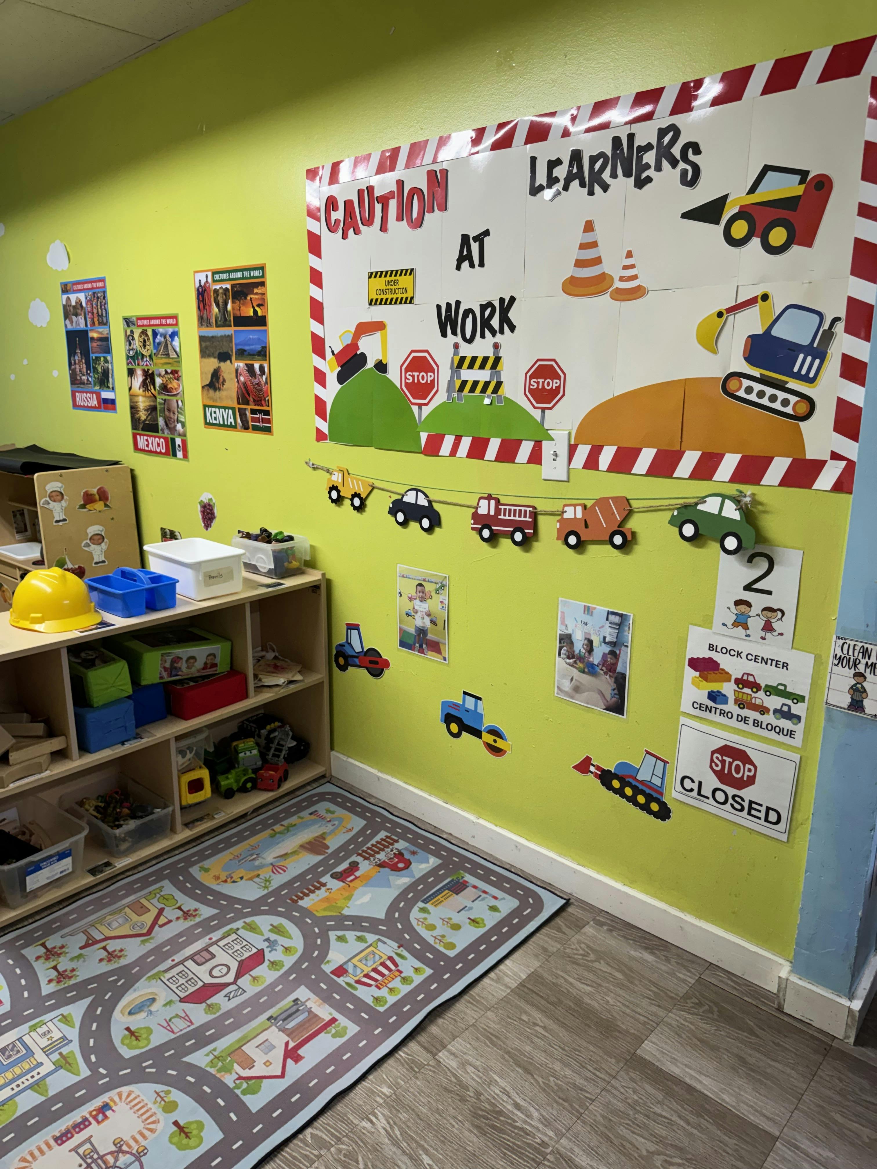 Classroom with a construction-themed bulletin board and rug