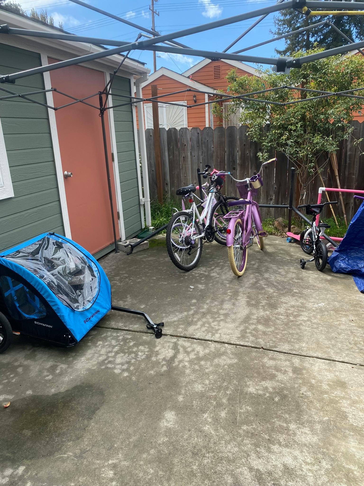 Bicycles and a child bike trailer on a concrete patio