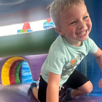 Child crawling in an inflatable bounce house