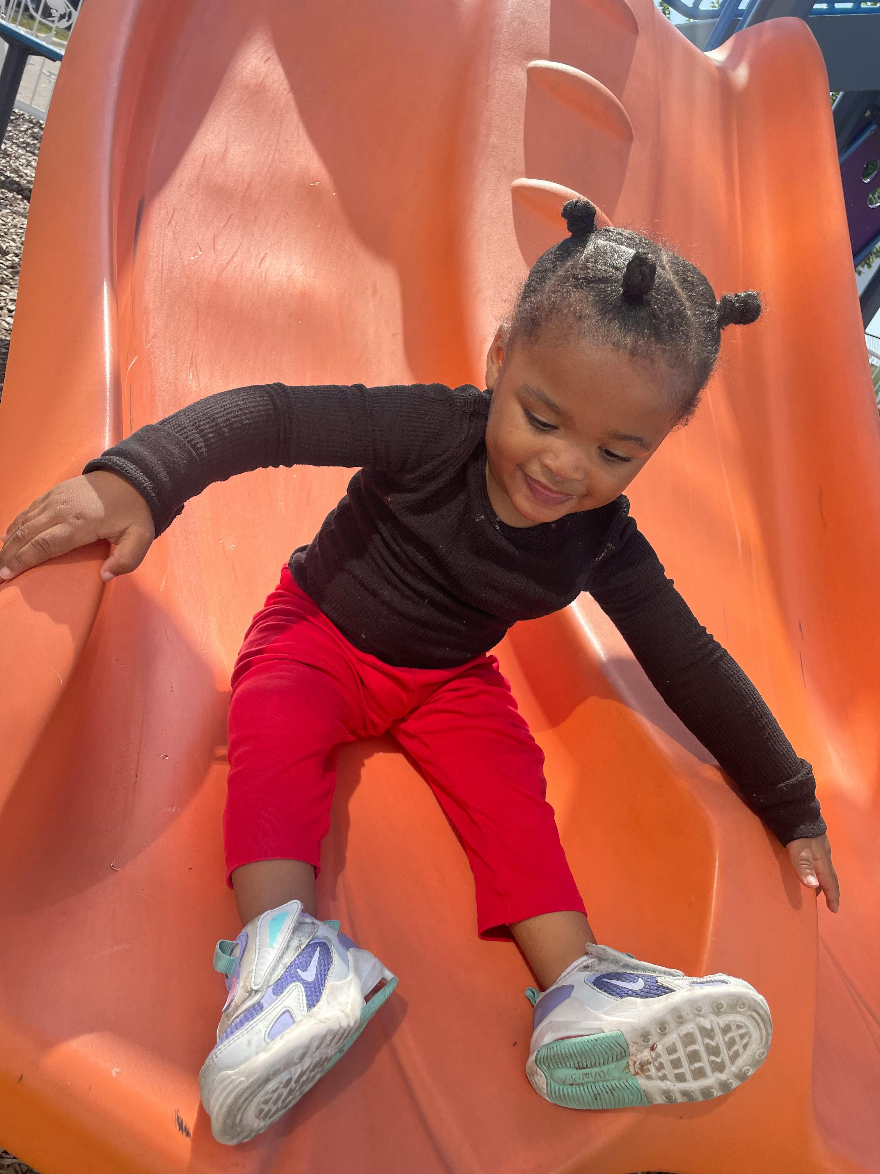 Child on an orange slide