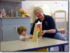 Adult and child playing with a toy