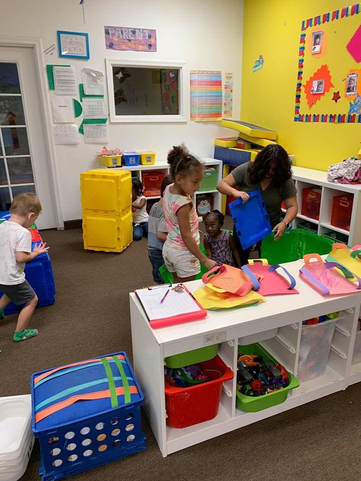 Adult and children playing in a classroom