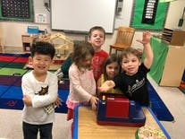 Five children in a classroom