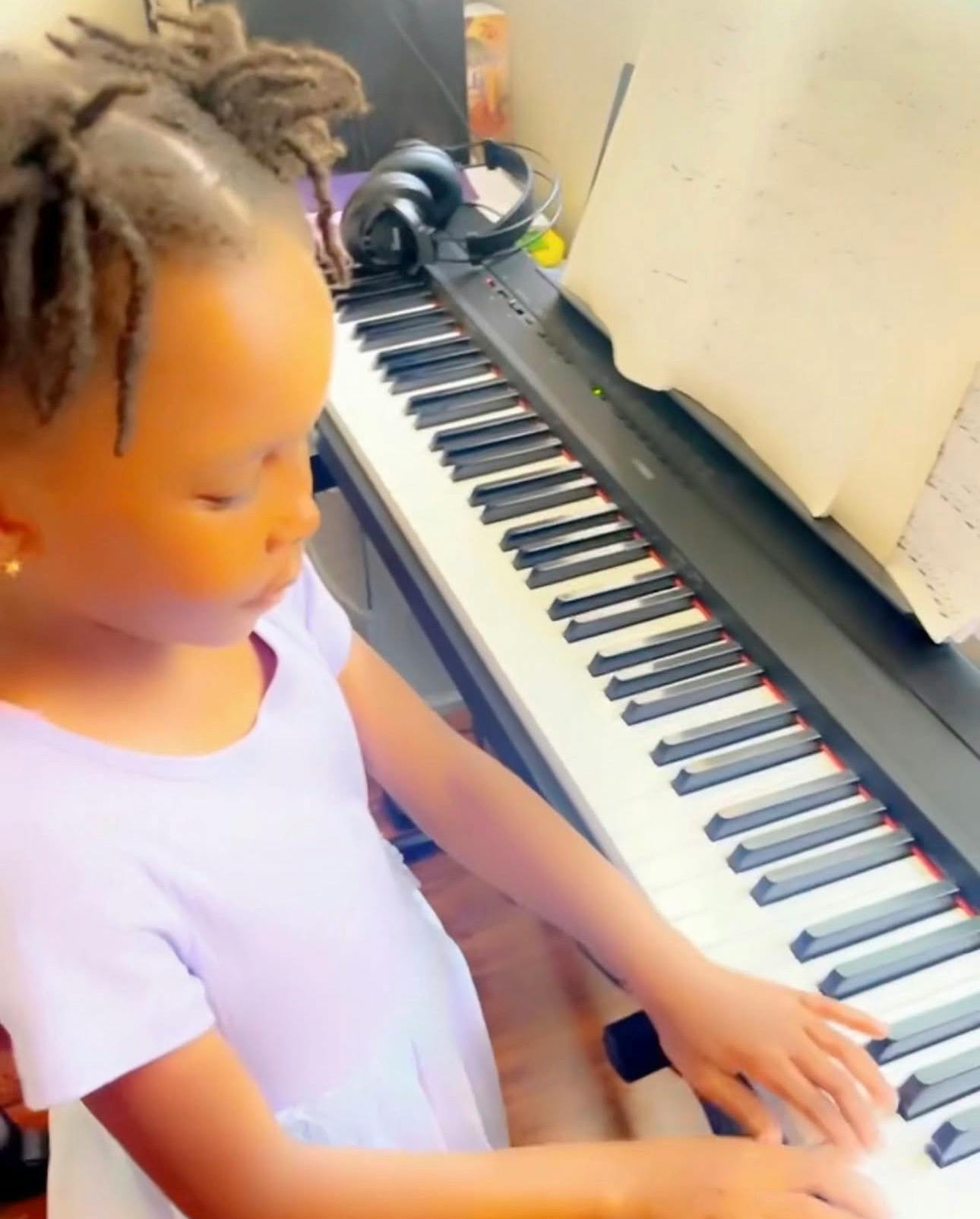 Child playing a digital piano