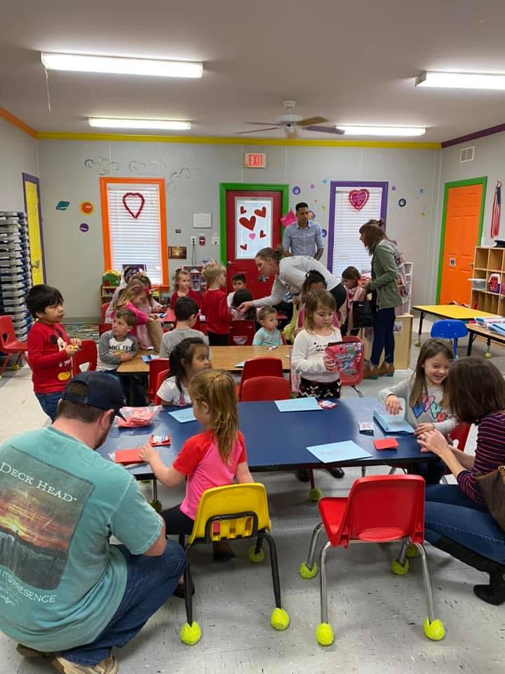 People and children gathered in a classroom