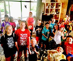 Group of children and adults in an indoor setting