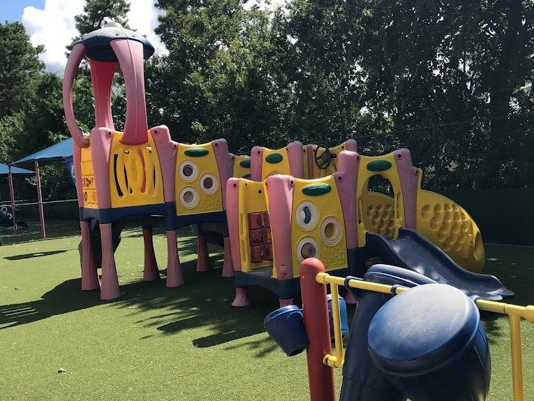 Colorful playground structure on green turf